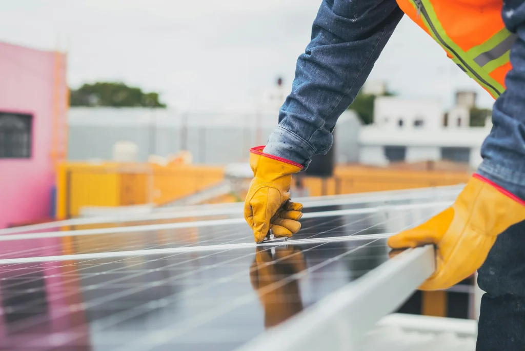 Electrician in Northampton holding solar panel.